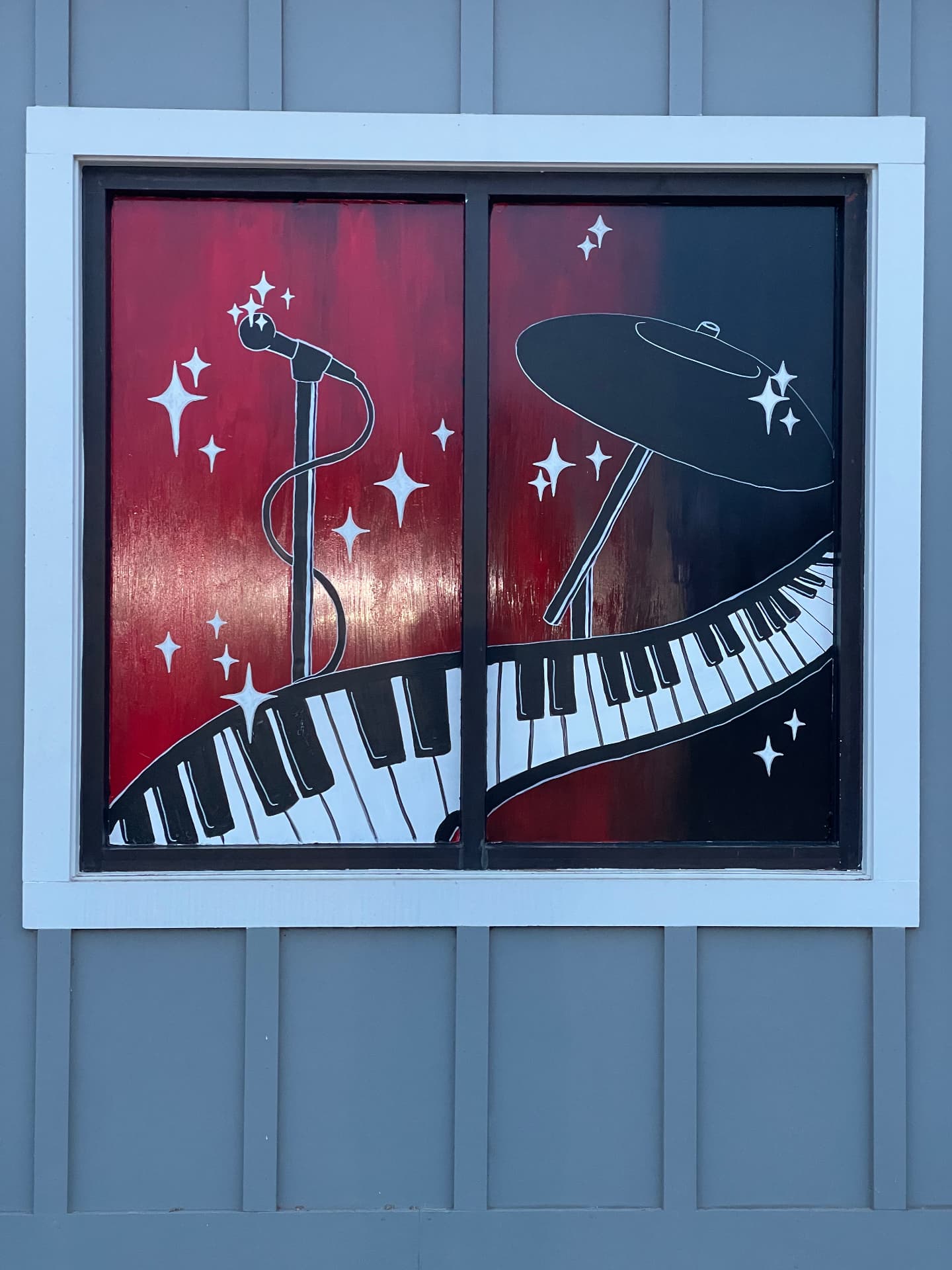 School of Rock window mural with a microphone, piano keys, and stars