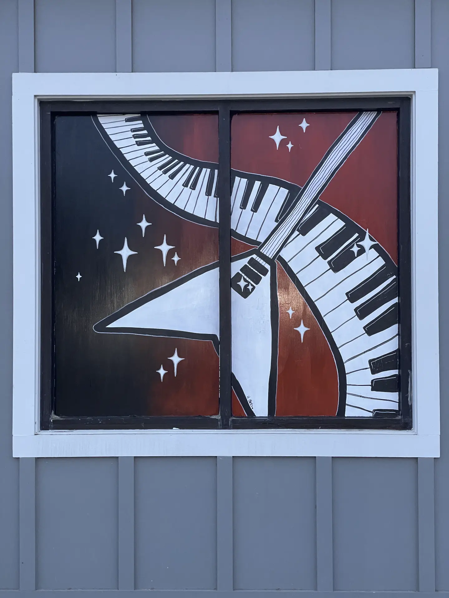 School of Rock window mural with guitar and curving piano keys